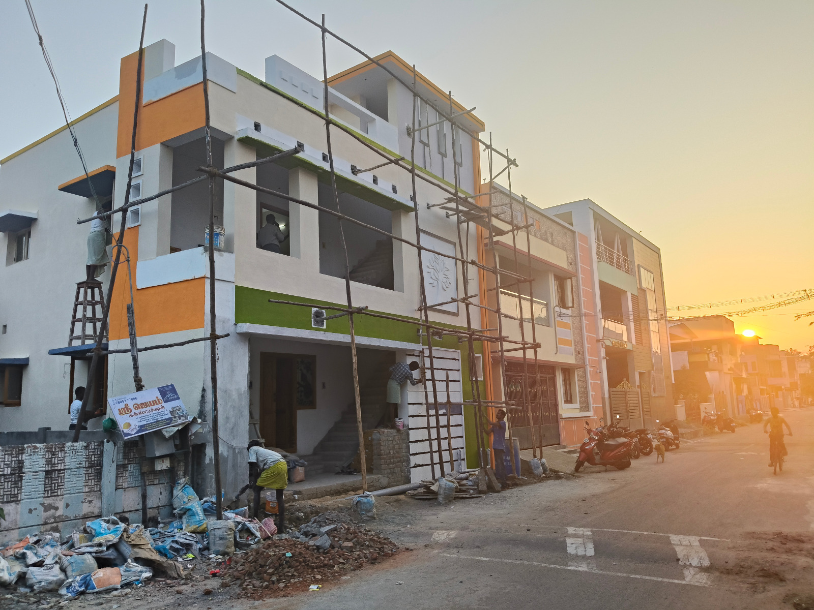 G+2 residential project with orange and green facade at finishing stage in Kumbakonam