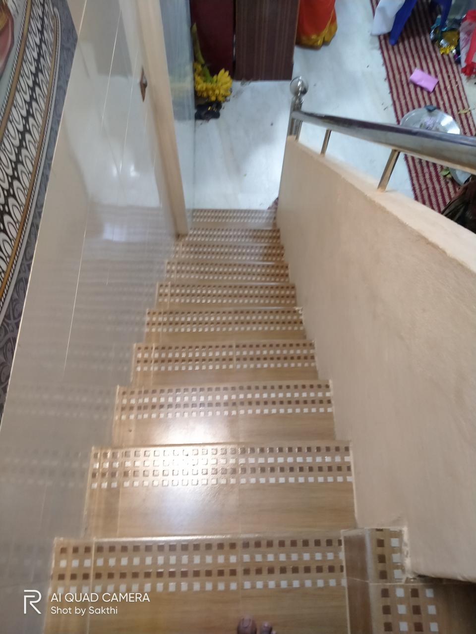 Kavery Metal renovation by Jayam Construction — completed mosaic-tiled staircase with stainless steel railing, Sarangapani Street, Kumbakonam