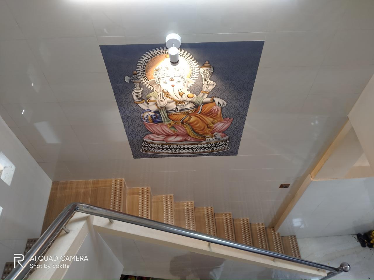 Kavery Metal renovation — overhead view of Ganesha mural ceiling tile, mosaic staircase steps and stainless steel railing, Kumbakonam